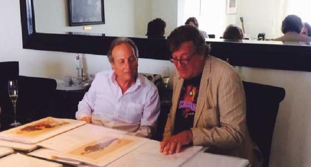Francis Spiteri Paris (left) showing his collection of lithographs to English comedian and actor Stephen Fry, who was cast as Oscar Wilde in his biopic