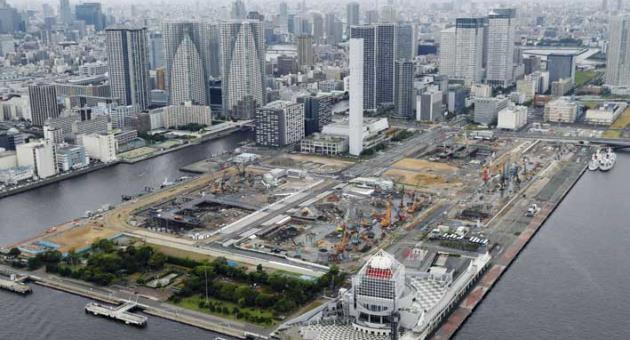 In this July 23, 2017 photo, the Olympic village is seen under construction in Tokyo. Japan has begun its three-year countdown to the 2020 Olympic Games in Tokyo with relays, concerts and dancing meant to help drum up public enthusiasm for the event. 