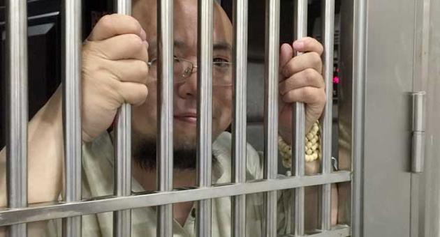 In this May 19, 2015 photo, Wu Gan also known as the Ultra Vulgar Butcher is seen behind bars at police station in Nanchang city in eastern China's Jiangxi province.