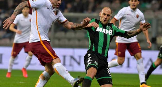 In this Tuesday, Feb. 2, 2016 file photo, Sassuolo's Paolo Cannavaro, right, vies for the ball with Roma's Radja Nainggolan, during a Serie A soccer match in Reggio Emilia, Italy. 