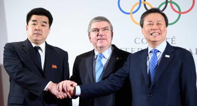International Olympic Committee, IOC, President Thomas Bach, center, from Germany shakes hands with North Korea's Olympic Committee President and sports minister Kim Il Guk, left, and South Korea's Sports Minister Do Jong-hwan, right, as they arrive for the North and South Korean Olympic Participation Meeting at the IOC headquarters in Pully near Lausanne, Saturday, Jan. 20, 2018.
