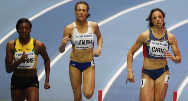Slovakia's Iveta Putalova, center, participates in a heat of the women's 400 meter at the World Athletics Indoor Championships in Birmingham, Britain, Friday, March 2, 2018. (AP Photo/Alastair Grant)