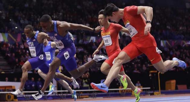 Bronze medalist United States' Ronnie Baker, left, gold medalist United States' Christian Coleman, center, and silver medalist China's Su Bingtian, right, cross the finish line in the men's 60 meters race at the World Athletics Indoor Championships in Birmingham, Britain, Saturday, March 3, 2018. (AP Photo/Matt Dunham)
