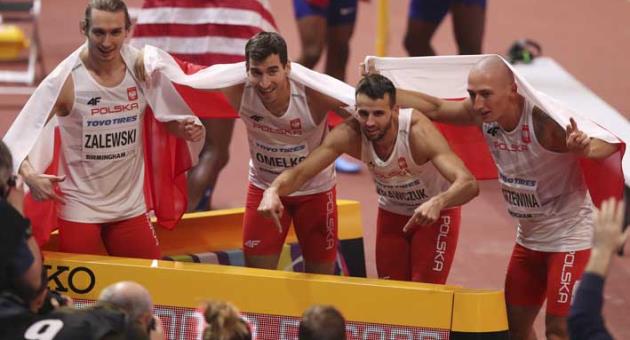 Poland's Karol Zalewski, Rafal Omelko, Lukasz Krawczuk and Jakub Krzewina, from left, celebrate after setting a new World Indoor Record when winning the gold medal in the men's 4x400-meter relay final at the World Athletics Indoor Championships in Birmingham, Britain, Sunday, March 4, 2018. (AP Photo/Alastair Grant)