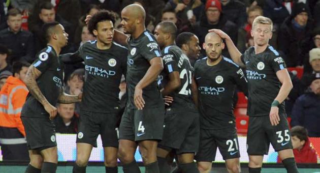 Manchester City's David Silva, second right, celebrates with teammates after scoring his side's first goal during the English Premier League soccer match between Stoke City and Manchester City at the Bet 365 Stadium in Stoke on Trent, England, Monday, March 12, 2018. (AP Photo/Rui Vieira)