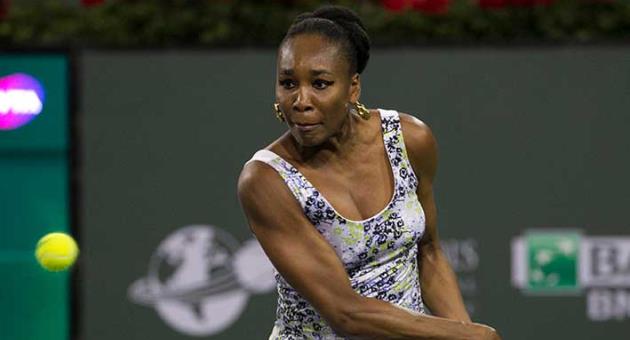 Venus Williams returns a shot to opponent and sister Serena Williams during the third round of the BNP Paribas Open tennis tournament at the Indian Wells Tennis Garden in Indian Wells, Calif., Monday, March 12, 2018. (AP Photo/Crystal Chatham)