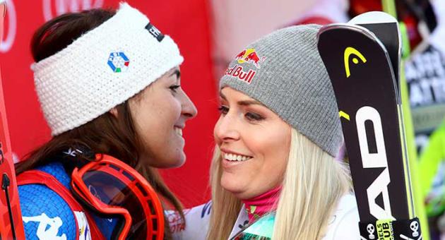 Italy's Sofia Goggia, left, congratulates United States' Lindsey Vonn after completing a women's World Cup downhill, at the alpine ski World Cup finals in Are, Sweden, Wednesday, March 14, 2018. (AP Photo/Alessandro Trovati)