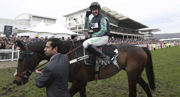 Jockey Nico de Boinville on Altior gestures after winning the Queen Mother Champion Chase at Cheltenham Racecourse Cheltenham England Wednesday March 14, 2018.. (Mike Egerton/PA via AP)