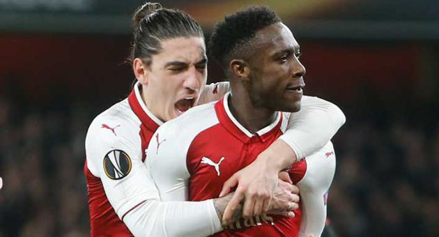 Arsenal's Danny Welbeck, right, celebrates with his teammate Hector Bellerin after scoring his side opening goal on a penalty, during the Europa League round of 16 second leg soccer match between Arsenal and AC Milan at the Emirates stadium in London, Thursday, March, 15, 2018. (AP Photo/Alastair Grant)