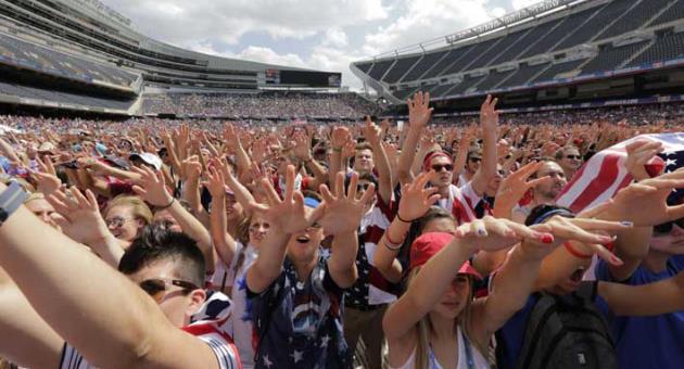 In this July 1, 2014, file photo, fans cheer for the United States against Belgium during a Brazil 2014 World Cup viewing party at Soldier Field in Chicago. Chicago, the home of the U.S. Soccer Federation, has dropped out of the North American bid for the 2026 World Cup. Organizers were to announce their list of bidding cities Thursday, March 15, 2018. (AP Photo/Stacy Thacker, File)