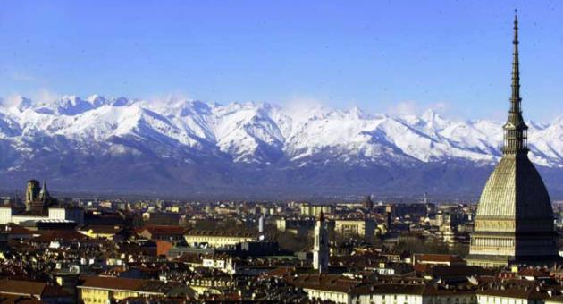 A view of Turin, Italy, with the main city landmark, the Mole Antonelliana, at right, and the Alps in background are seen in this December 2005 photo. Milan and Turin are in discussions with the Italian Olympic Committee over a possible bid for the 2026 Winter Games. Turin Mayor Chiara Appendino sent a letter of interest to CONI on Sunday despite divisions in her own party, the populist 5-Star Movement, on a candidacy. (AP Photo/Massimo Pinca)