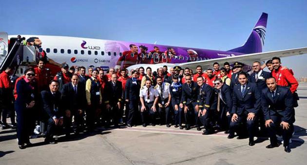 In this Tuesday, March 20, 2018 photo released by Egypt's national Airline, Egypt Air, the Egyptian national football team and Egypt Air staff pose for a photo in front of a specially decorated plane that will take them to Russia for the 2018 FIFA World cup, at Cairo Airport, Egypt. Egypt’s first World Cup warmup will be against Portugal in a match that could have two of the most prolific scorers in soccer going up against each other. The Egyptians will be led by Liverpool forward Mohammed Salah. On the other side is Cristiano Ronaldo. (Egypt Air via AP)
