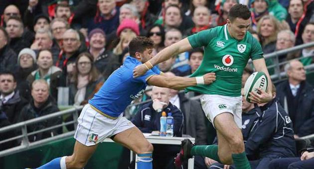 This is a Saturday, Feb. 10, 2018 file photo of Ireland's Jacob Stockdale, carries the ball as Italy's Marcello Violi, left, attempts a tackle during the Six Nations rugby union match between Ireland and Italy at the Aviva stadium in Dublin, Ireland. Winger Jacob Stockdale has been chosen the best player of the Six Nations after scoring seven tries, the most in the championship in 93 years. Stockdale was a clear winner in the public vote, receiving 32 percent. (AP Photo/Peter Morrison/File)
