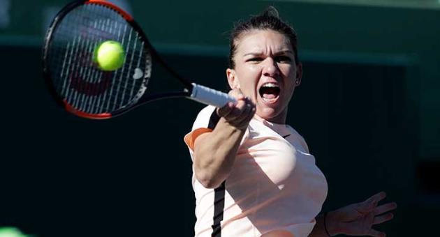 Simona Halep, of Romania, returns to Oceane Dodin, of France, during the Miami Open tennis tournament, Thursday, March 22, 2018, in Key Biscayne, Fla. Halep won 3-6, 6-3, 7-5. (AP Photo/Lynne Sladky)