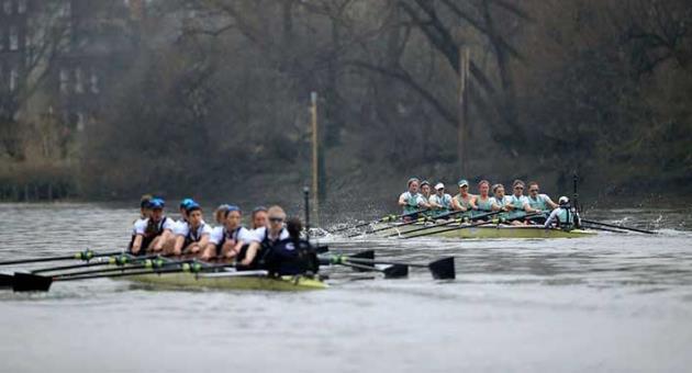 Oxford University Women's Boat Club, left, and Cambridge University Women's Boat Club in action during the Women's Boat Race on the River Thames, London, Saturday March 24, 2018. (Adam Davy/PA via AP)
