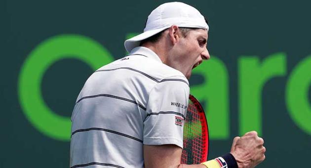John Isner reacts after winning a point against Marin Cilic, of Croatia, during the Miami Open tennis tournament, Tuesday, March 27, 2018, in Key Biscayne, Fla. Isner won 7-6 (0), 6-3. (AP Photo/Lynne Sladky)