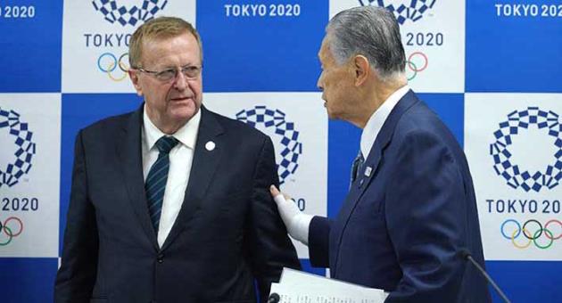 International Olympic Committee (IOC) Vice President John Coates, left, and Yoshiro Mori, president of the Tokyo Organizing Committee of the Olympic and Paralympic Games, walk together after their joint press conference in Tokyo Tuesday, April 24, 2018. Coates, the head of an IOC inspection team, urged organizers of the 2020 Tokyo Olympics to be more direct answering questions about preparations with the Games opening in just over two years. The advice from Coates on Tuesday came a week after several sports federations openly criticized Tokyo's preparations. (AP Photo/Eugene Hoshiko)