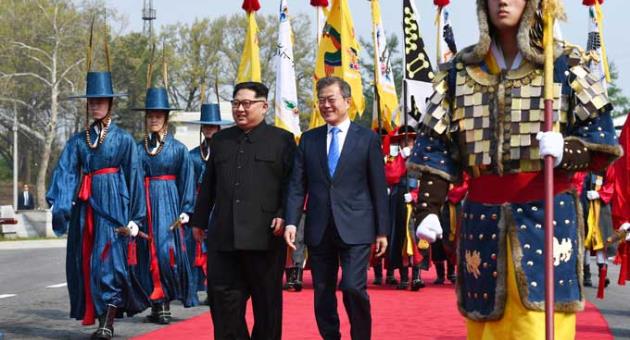 North Korean leader Kim Jong Un, left, and South Korean President Moon Jae-in walk together at the border village of Panmunjom in the Demilitarized Zone Friday, April 27, 2018. 