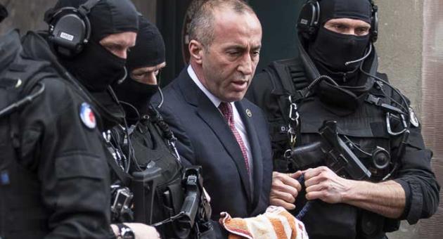 In this Thursday, Jan. 12, 2017 file photo, Former Prime Minister of Kosovo Ramush Haradinaj, center, leaves the court escorted by hooded police officers in Colmar, eastern France. Kosovo’s prime minister has resigned from the post after he has been invited to be questioned from a European Union-funded court investigating crimes against ethnic Serbs during and after the 1998-99 independence war with Serbia. Haradinaj said on Friday, July 19, 2019 he had informed the Cabinet of his resignation and urged the country’s president to set a date for an early parliamentary election. (AP Photo/Jean-Francois Badias)