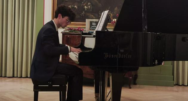 Thomas playing one of the eight pieces he selected for his recital