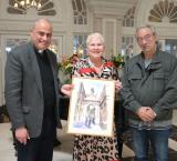 Fr Charles Cini and Julian Holland presenting the painting to Ms Robyn Pratt, General Manager of The Phoenicia Malta.