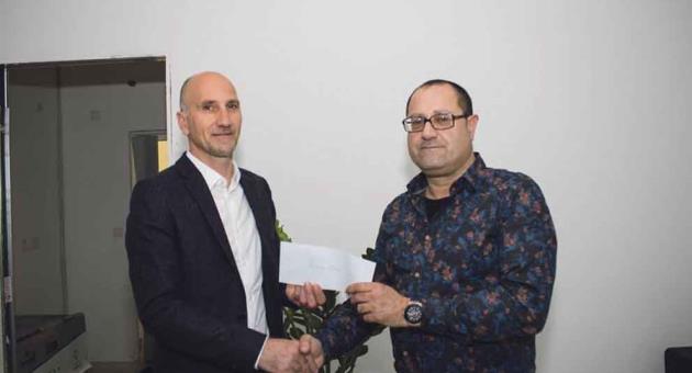 MBR Publications managing director Martin Vella handing over the cheque to Dr Andrew Decelis