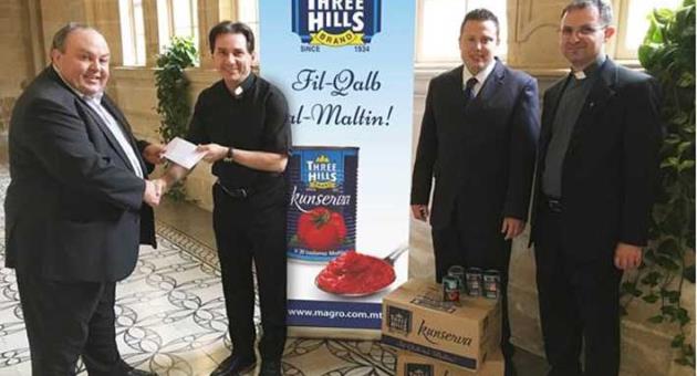 Mr John Magro and his son Nicholas presenting a donation to Fr Ray Francalanza, Prior of the Agostinian Friars in Rabat, Malta, as a sign of gratitude for their collaboration in their project “60 most common surnames of the Maltese Islands”.