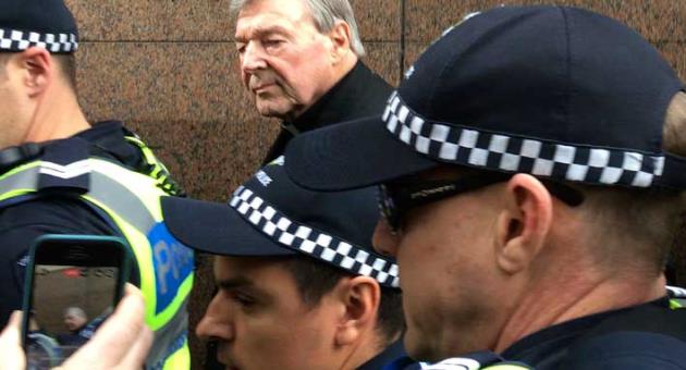 Cardinal George Pell, rear center, Australia's highest-ranking Catholic and Pope Francis' top financial adviser, leaves Melbourne Magistrates' Court Wednesday, July 26, 2017.