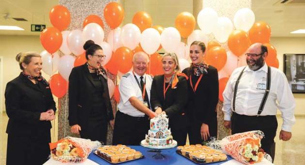 Leslie Vella, chief officer Strategic Development/deputy CEO (MTA) [right], together with Captain Adam Stoaling and the easyJet crew, cutting the celebratory cake