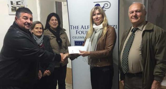 Jane Mizzi presenting Mark Vella with The Alfred Mizzi Foundation’s contribution
