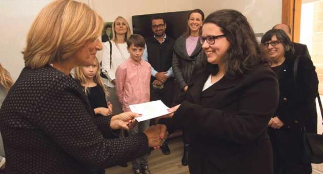 Mary Rose Chalmers congratulating Graziella Rose Zammit, surrounded by members of both families