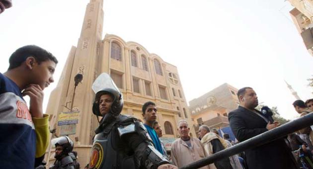 Policemen surround Mar Mina church, in Helwan, Cairo, Egypt, Friday, Dec. 29, 2017, where at least 10 people, including eight Coptic Christians, have been killed in a shootout outside the church. 