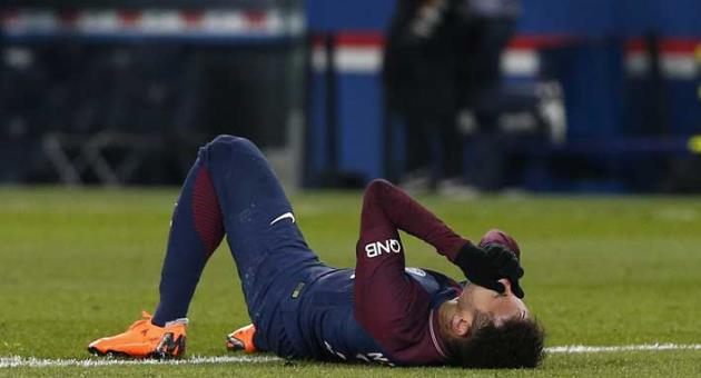 PSG's Neymar lays on the pitch after being fouled during the French League One soccer match between Paris Saint-Germain and Marseille at the Parc des Princes Stadium, in Paris, France, Sunday, Feb. 25, 2018. (AP Photo/Thibault Camus)