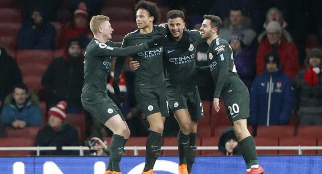 Manchester City's Leroy Sane, second left, celebrates with teammates after scoring his side's third goal during the English Premier League soccer match between Arsenal and Manchester City at the Emirates stadium in London, Thursday, March 1, 2018.(AP Photo/Frank Augstein)