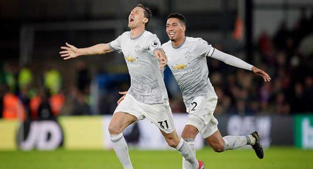 Manchester United's Nemanja Matic, foreground celebrates after scoring a goal with teammate Chris Smalling during the English Premier League soccer match between Crystal Palace and Manchester United at Selhurst Park in London, Monday, March 5, 2018. (AP Photo/Tim Ireland)