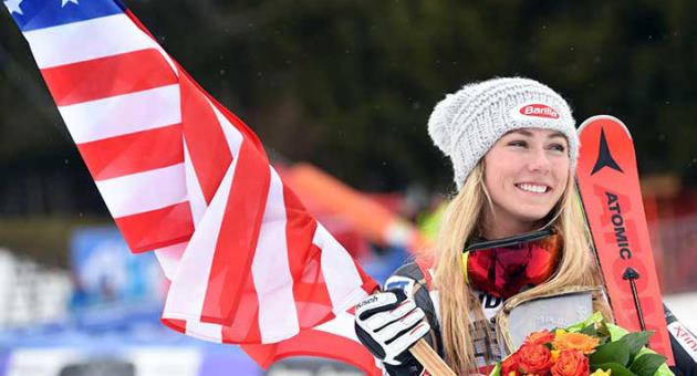 United States' Mikaela Shiffrin holds a US flag as she celebrates after winning an alpine ski, women's World Cup slalom, in Ofterschwang, Germany, Saturday, March 10, 2018. (AP Photo/Marco Tacca)