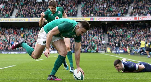 Ireland's Jacob Stockdale scores a try against Scotland during the Six Nations rugby match at the Aviva Stadium in Dublin, Ireland, Saturday March 10, 2018. (Brian Lawless/PA via AP)