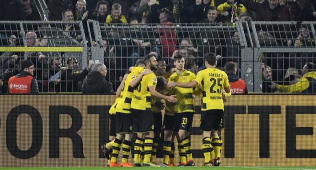 Dortmund's Michy Batshuayi is celebrated after scoring the final goal in the additional time during the German Bundesliga soccer match between Borussia Dortmund and Eintracht Frankfurt in Dortmund, Germany, Sunday, March 11, 2018. Dortmund defeated Frankfurt in a dramatic 3-2. (AP Photo/Martin Meissner)