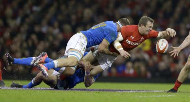 Italy's Giovanni Licata, left tackles Wales' Hadleigh Parkes during the Six Nations rugby union match between Wales and Italy at the Principality Stadium in Cardiff, Wales, Sunday, March 11, 2018. (AP Photo/Alastair Grant)