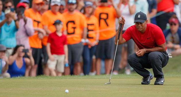 Tiger Woods lines up a putt on the 13th hole during the final round of the Valspar Championship golf tournament Sunday, March 11, 2018, in Palm Harbor, Fla. (AP Photo/Mike Carlson)