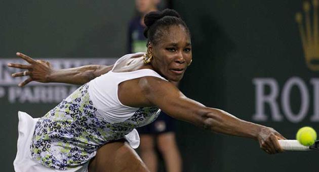 Venus Williams stretches to return a shot to opponent and sister Serena Williams during the third round of the BNP Paribas Open tennis tournament at the Indian Wells Tennis Garden in Indian Wells, Calif., Monday, March 12, 2018. (AP Photo/Crystal Chatham)