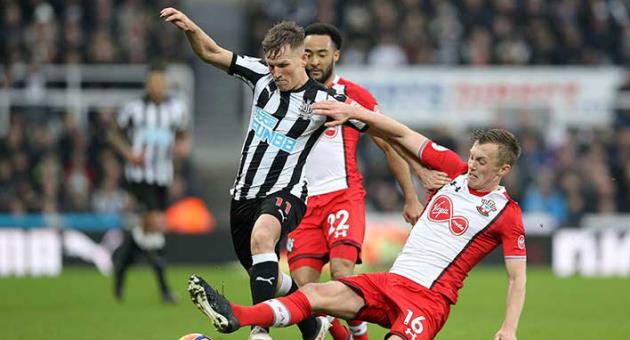 Newcastle United's Matt Ritchie, left, clashes with Southampton's James Ward-Prowse during their English Premier League soccer match at St James' Park in Newcastle, Saturday March 10, 2018. (Owen Humphreys/PA via AP)