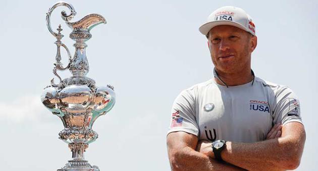 In this June 16, 2017, file photo, Oracle Team USA skipper and helmsman Jimmy Spithill stands alongside the America's Cup trophy, known as the 