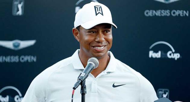 In this Feb. 16, 2018, file photo, Tiger Woods talks to reporters following his second round of the Genesis Open golf tournament at Riviera Country Club in the Pacific Palisades area of Los Angeles. Tiger Woods and Ernie Els will duel in the Presidents Cup again, this time as captains. Woods and Els have agreed to be captains for the 2019 matches in Melbourne, Australia, according to two people involved in the Presidents Cup. They spoke on condition of anonymity because the captain selections have not been announced. (AP Photo/Ryan Kang, File)