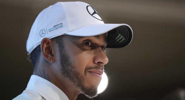 In this Wednesday, Nov. 29, 2017 file photo, Mercedes Formula One driver Lewis Hamilton of Britain listens to a question from the media during a celebratory event by Petronas in Kuala Lumpur, Malaysia. Hamilton is entering the final season of his three-year contract with Mercedes but talks are underway about a new deal with Mercedes executive director Toto Wolff. The British driver had said last month he hoped to get it done before the new season gets underway but he admitted Wednesday, March 14, 2018 that that is now unlikely to happen before the first race in Melbourne on March 25.(AP Photo/Vincent Thian, file)