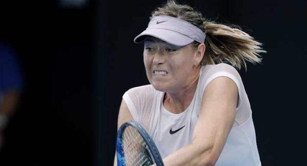 In this Jan. 20, 2018, file photo, Russia's Maria Sharapova hits a backhand return to Germany's Angelique Kerber during their third round match at the Australian Open tennis championships, in Melbourne, Australia. Five-time Grand Slam champion Maria Sharapova has withdrawn from the Miami Open that begins next week because of a left forearm injury. Sharapova announced the decision on Friday, March 16, 2018. (AP Photo/Vincent Thian, File)