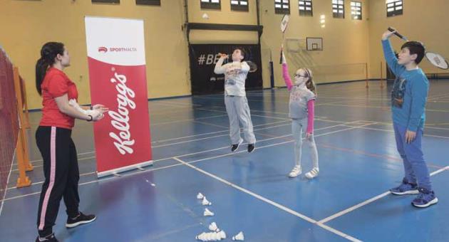 : #OnTheMove coach Melanie Grech training some of the young participants how to hit the shuttlecock