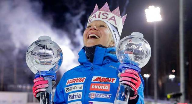 Finland's Kaisa Makarainen poses with the Biathlon women's World Cup mass start and overall trophies, in Tyumen, Russia, Sunday, March 25, 2018. (AP Photo/Sergei Grits)