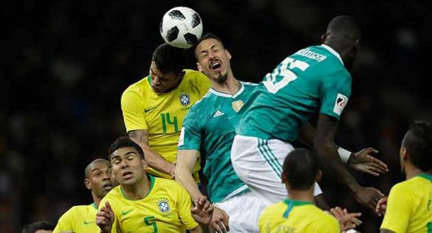 Germany's Sandro Wagner, center, is airborne with Brazil's Thiago Silva during the international friendly soccer match between Germany and Brazil in Berlin, Germany, Tuesday, March 27, 2018. (AP Photo/Michael Sohn)