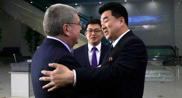 International Olympic Committee (IOC) President Thomas Bach, left, is greeted by North Korean Sports Minister Kim Il Guk on his arrival at the Pyongyang Airport in North Korea, Thursday, March 29, 2018. IOC President Bach arrived in North Korea on Thursday after playing a key role in allowing it to participate in last month's Pyeongchang Olympic Games in South Korea. (AP Photo/Jon Chol Jin)